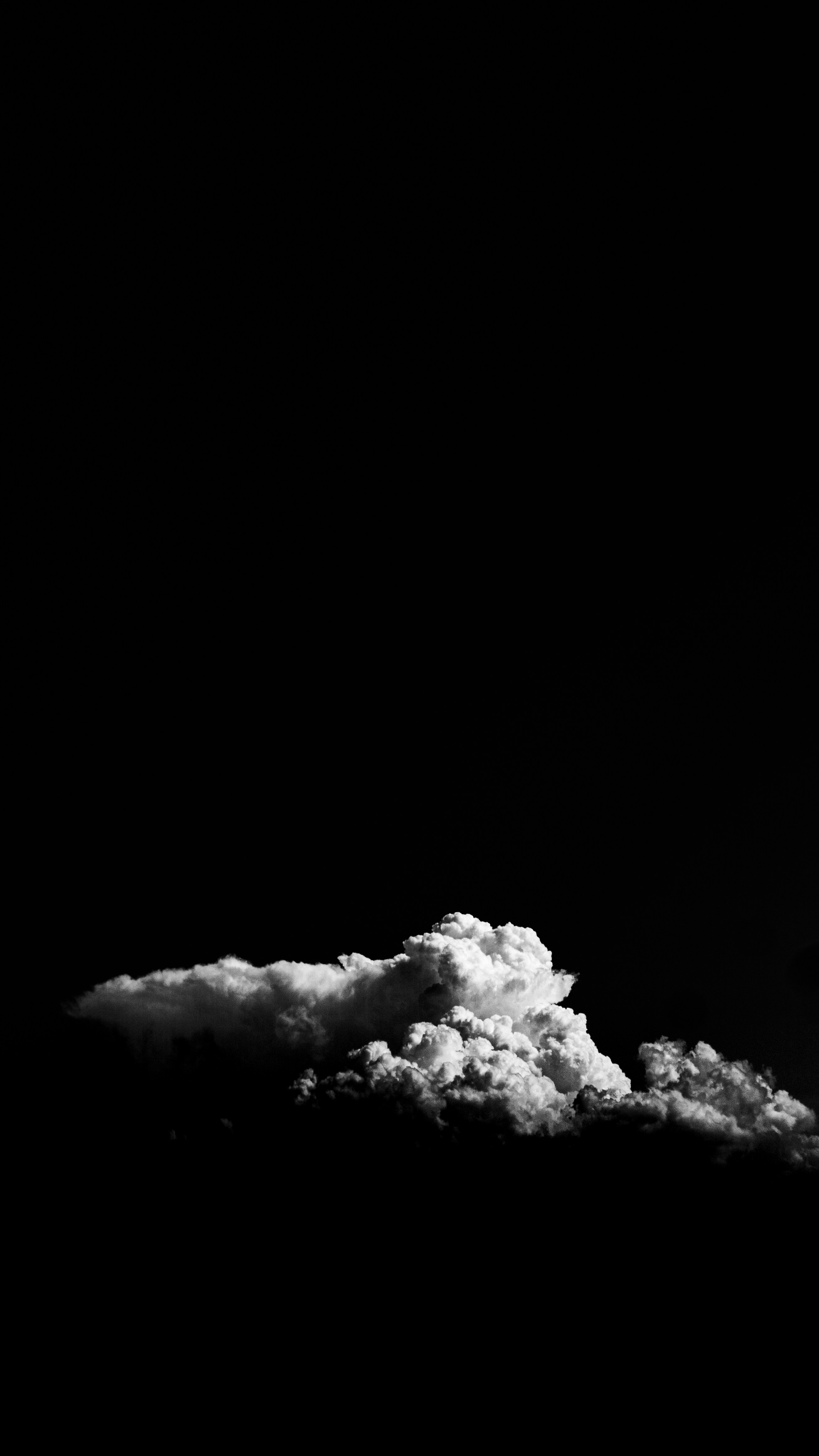 A black and white photo of the moon and clouds