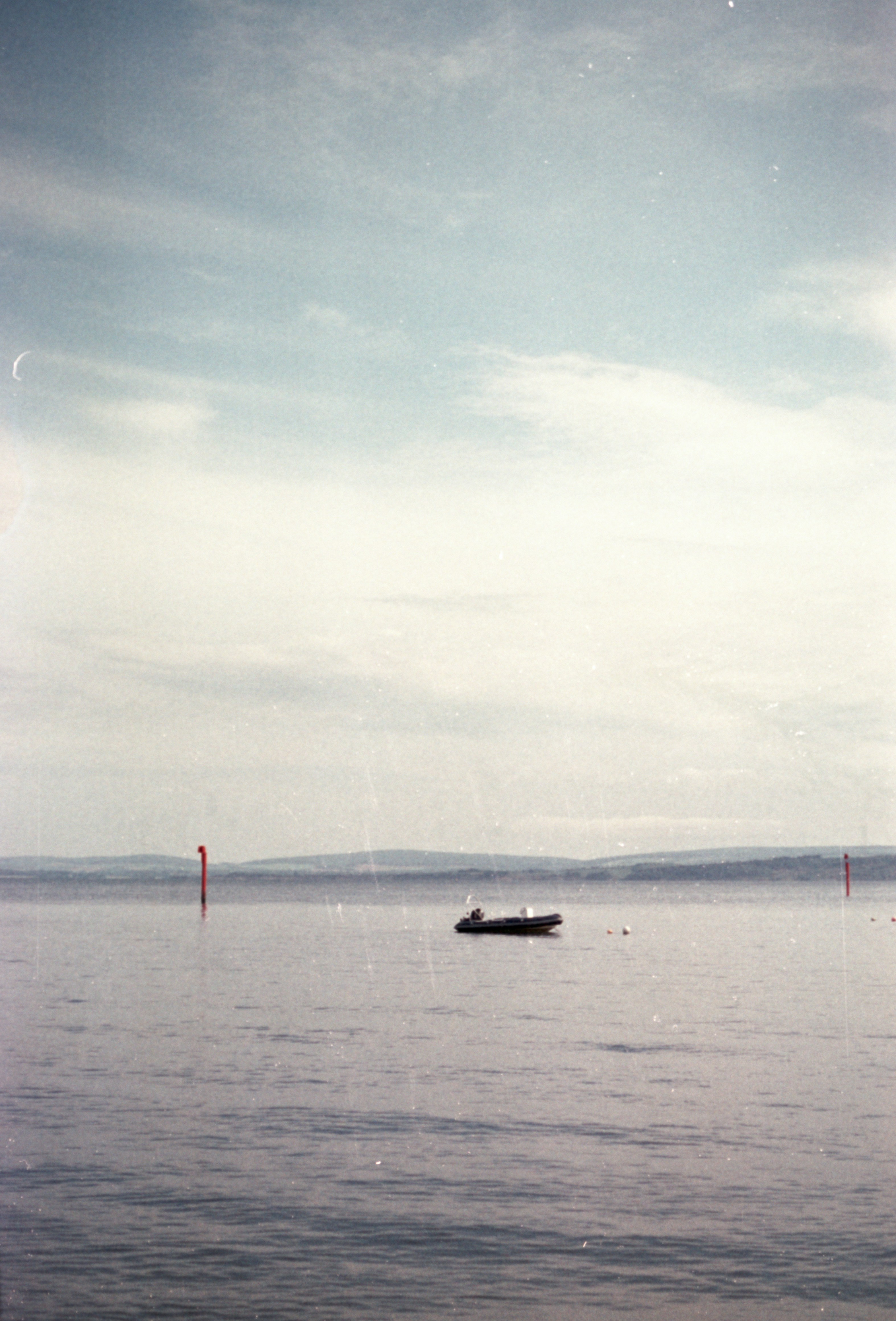 A boat floating on top of a large body of water