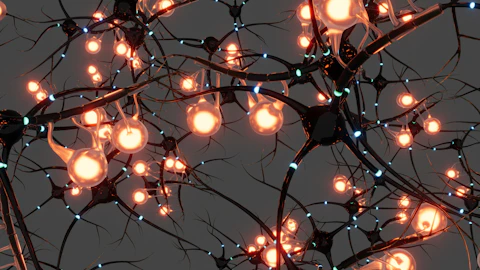 Interconnected dark nerve cells with glowing orange nodes and small blue light pulses