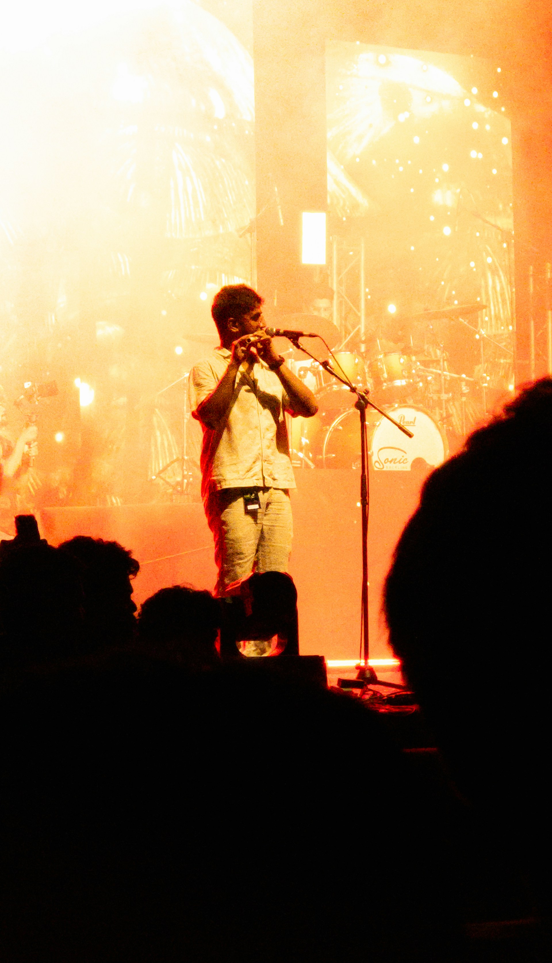 A man standing on top of a stage holding a microphone