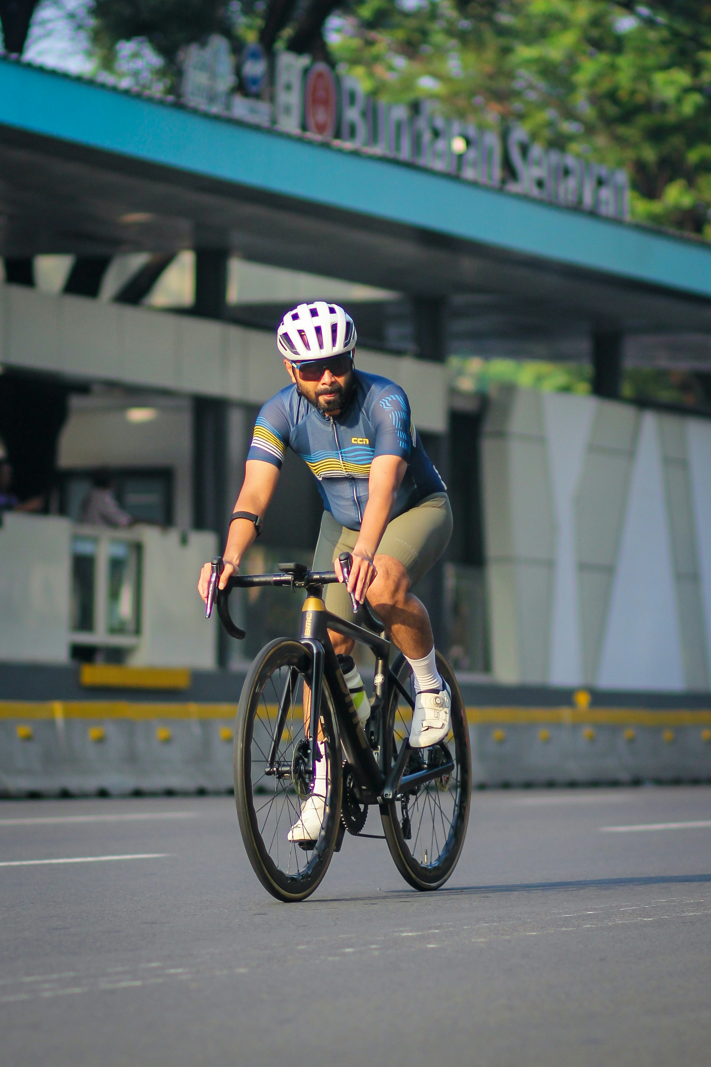 A man riding a bike down a street