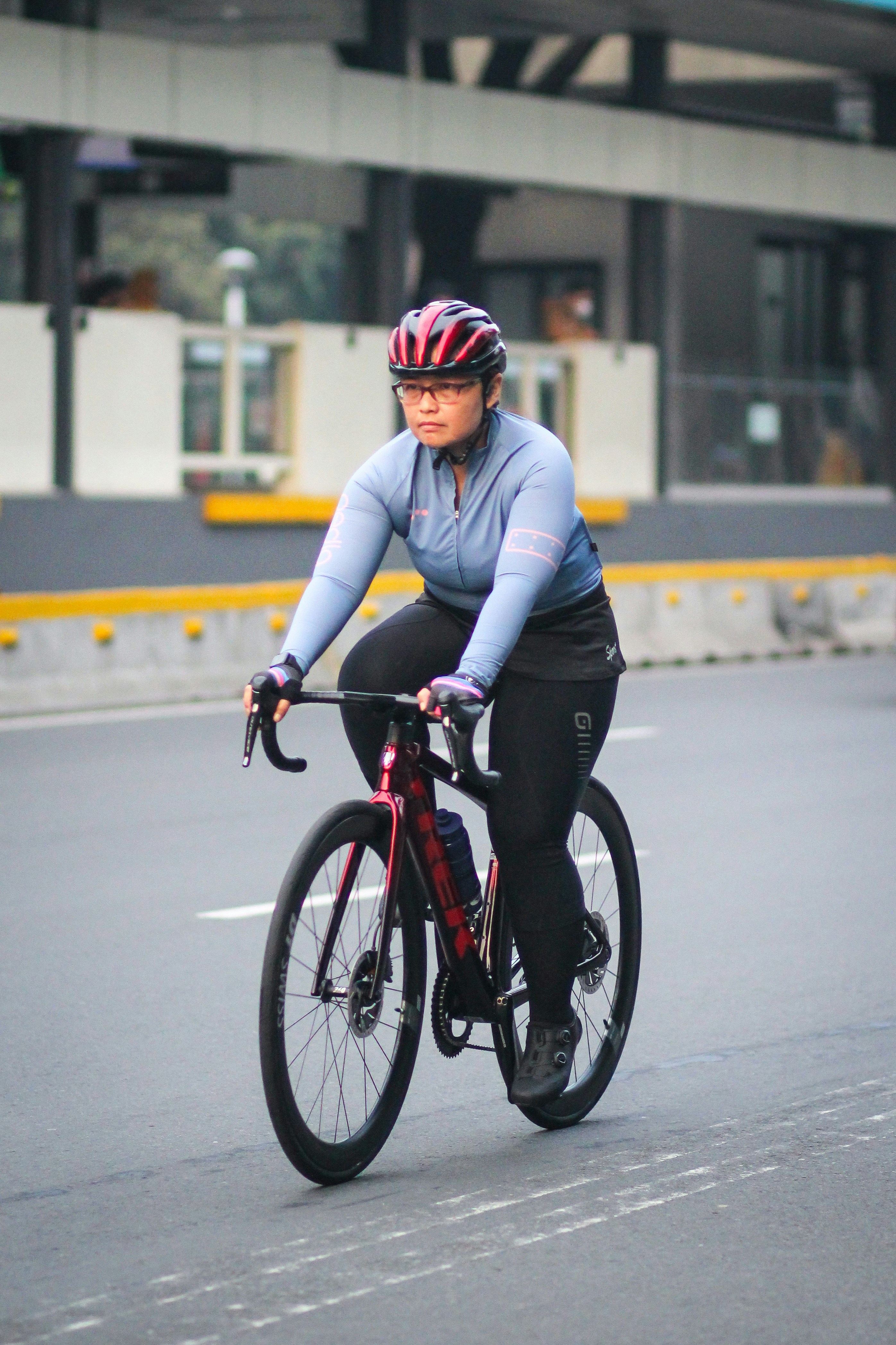 A woman riding a bike down a street