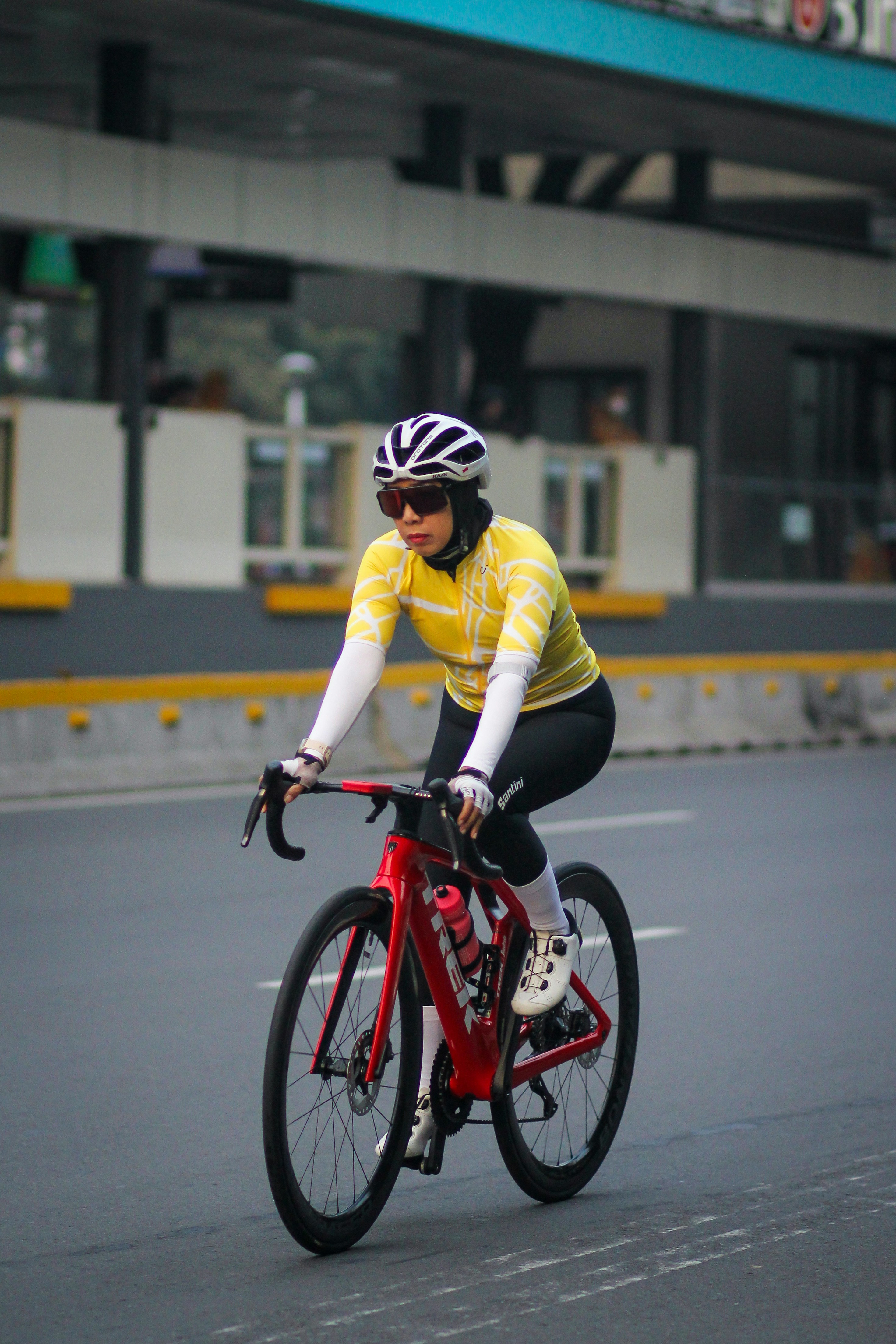 A man riding a red bike down a street