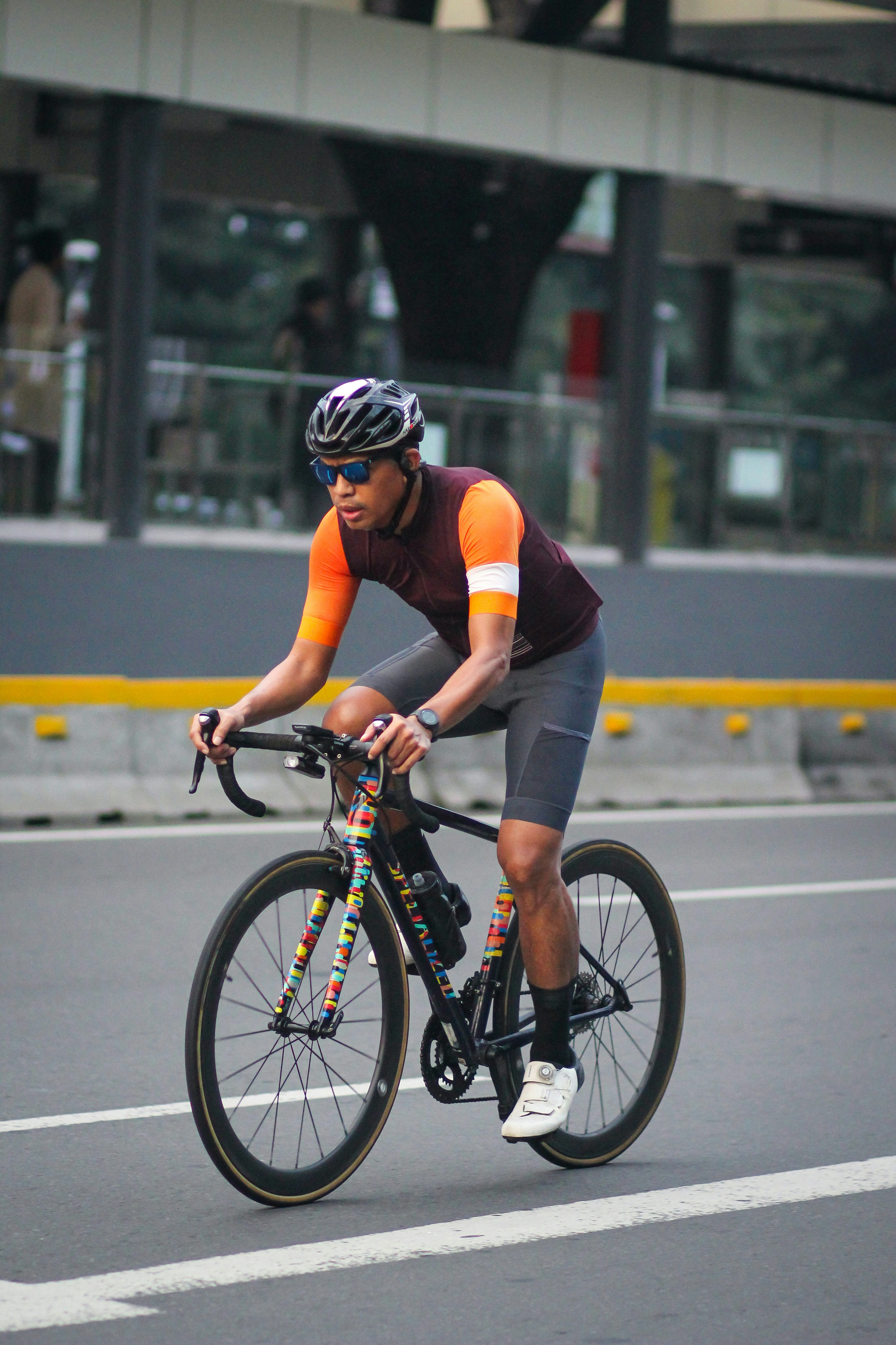 A man riding a bike down a street