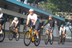 A group of people riding bikes down a street