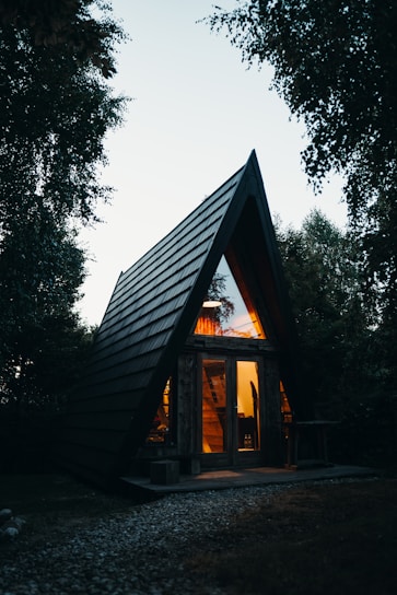 A small wooden cabin with a pitched roof