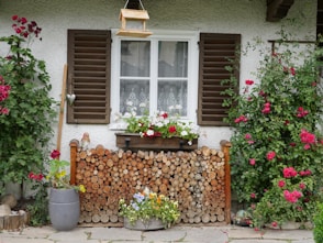 A house that has a bunch of flowers in front of it