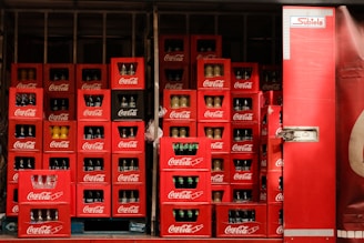 A large display of coca - cola bottles in a store