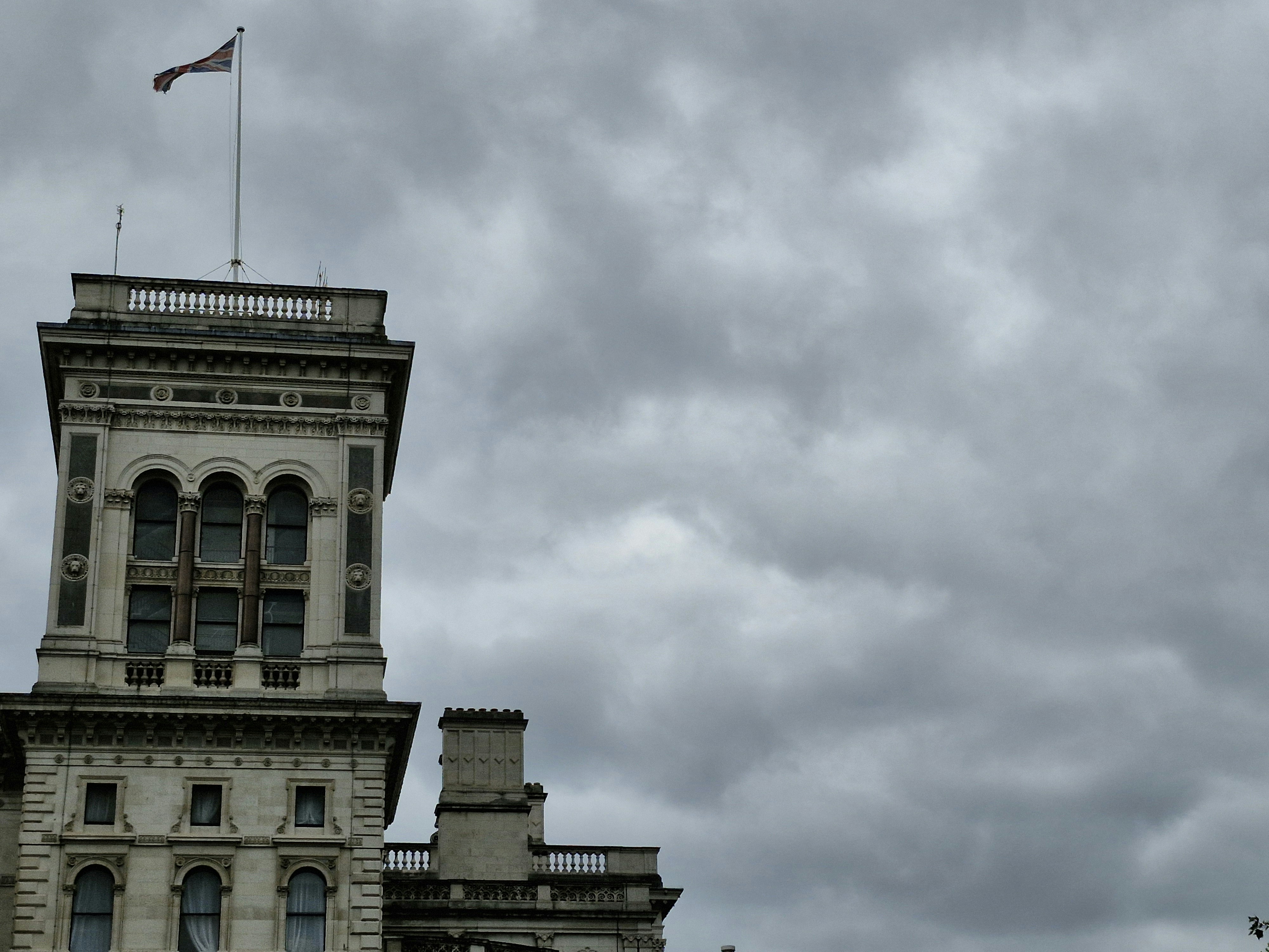 A tall building with a flag on top of it