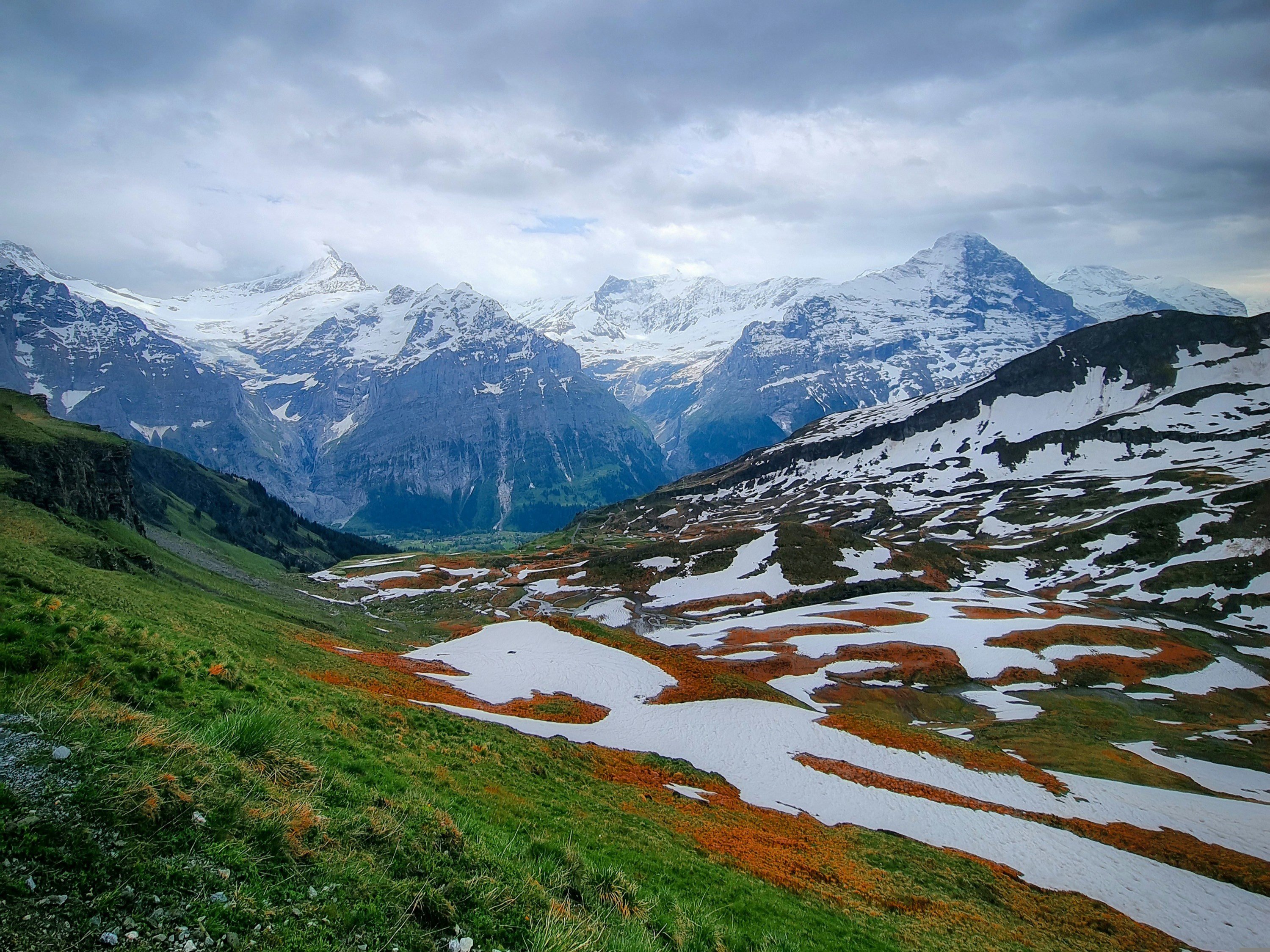 A view of a mountain range with snow on the mountains, This shot was witnessed as one hikes from Grindelwald-First towards Bachalpsee.