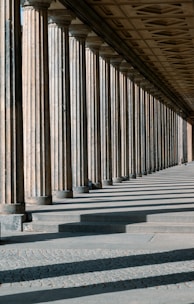 A man riding a skateboard down a street under a bridge