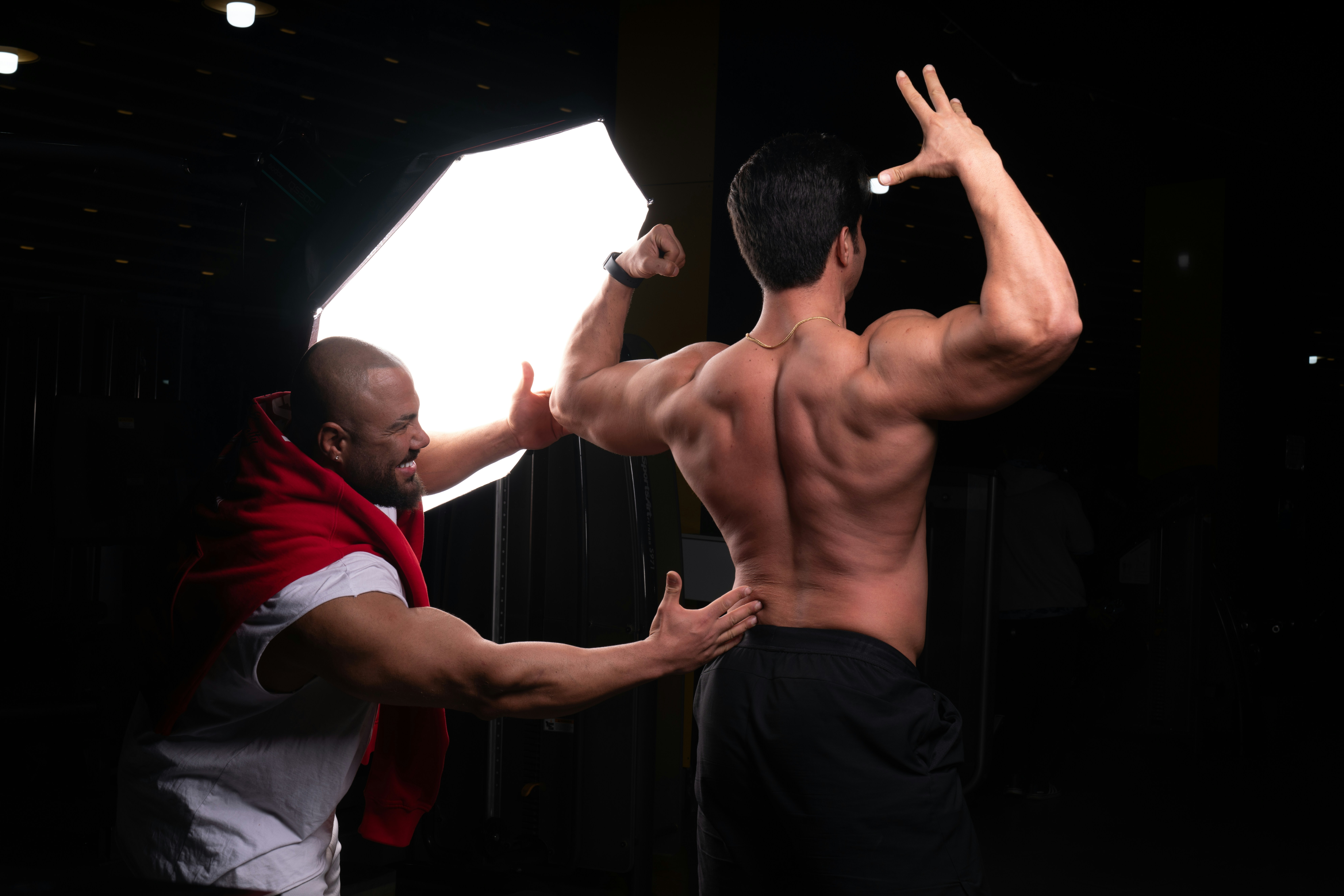 Male strength coach demonstrating kettlebell swing