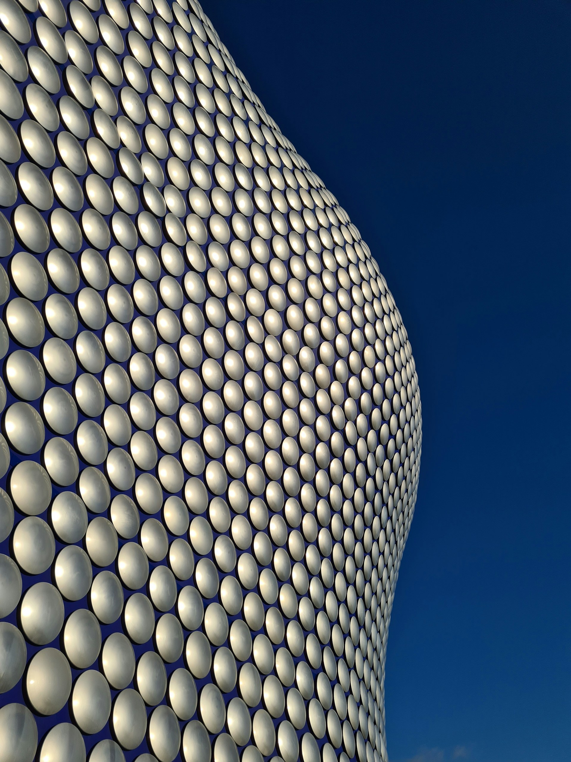 A tall building with a lot of white balls on it