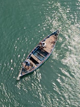 A small boat floating on top of a body of water