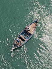 A small boat floating on top of a body of water