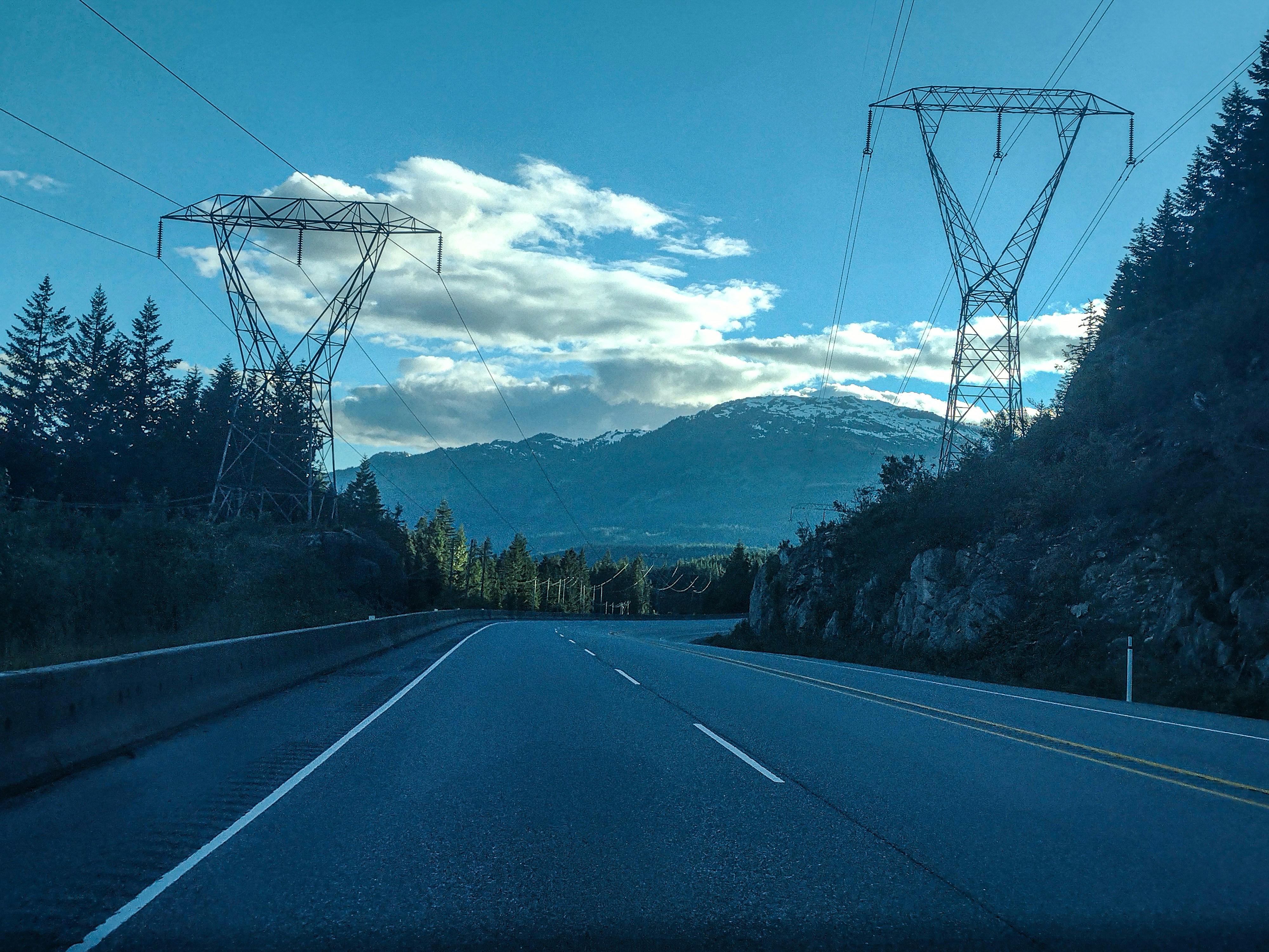 Electric SUV driving on a wet highway with all-season tires evacuating water