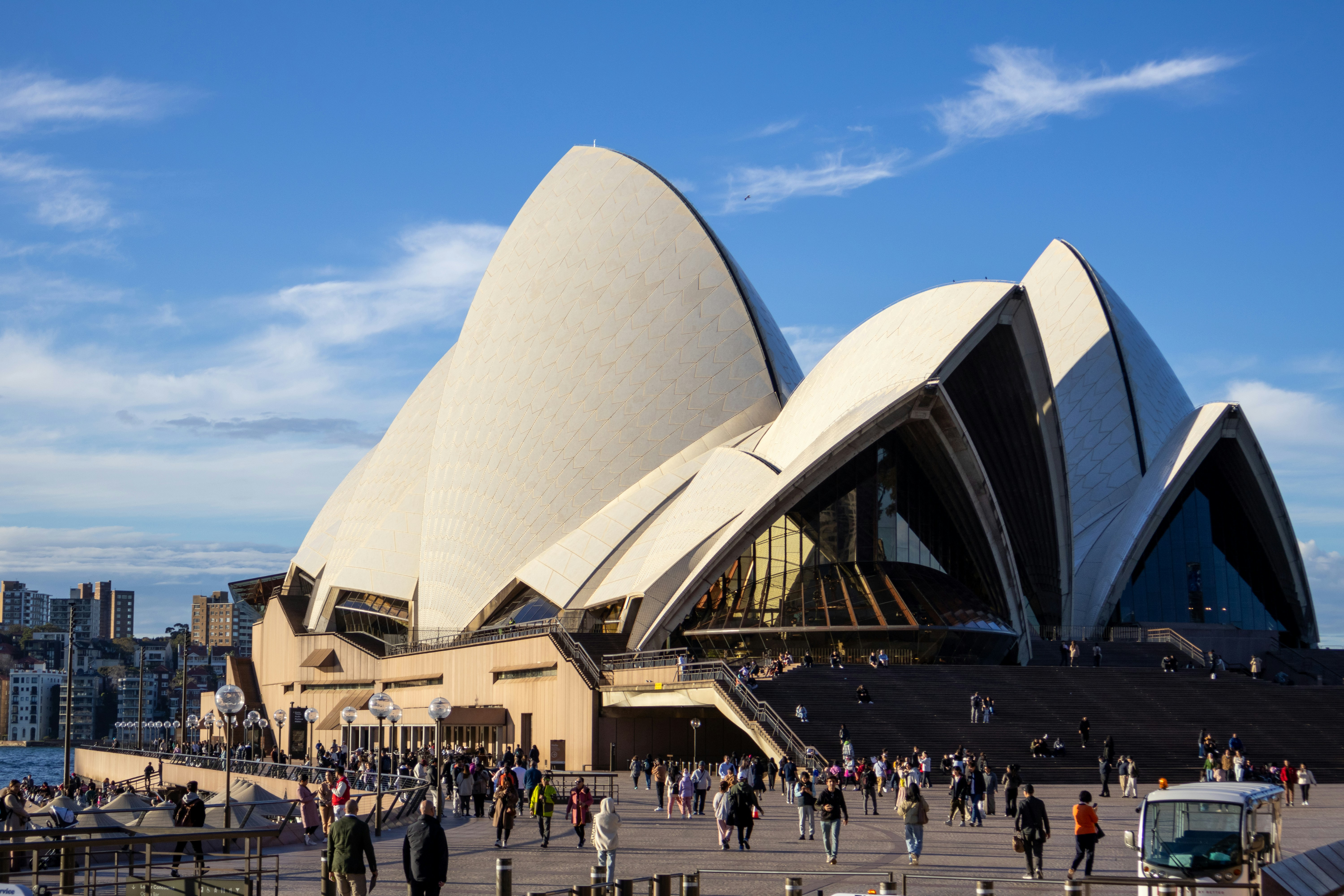 A crowd of people walking around a large building