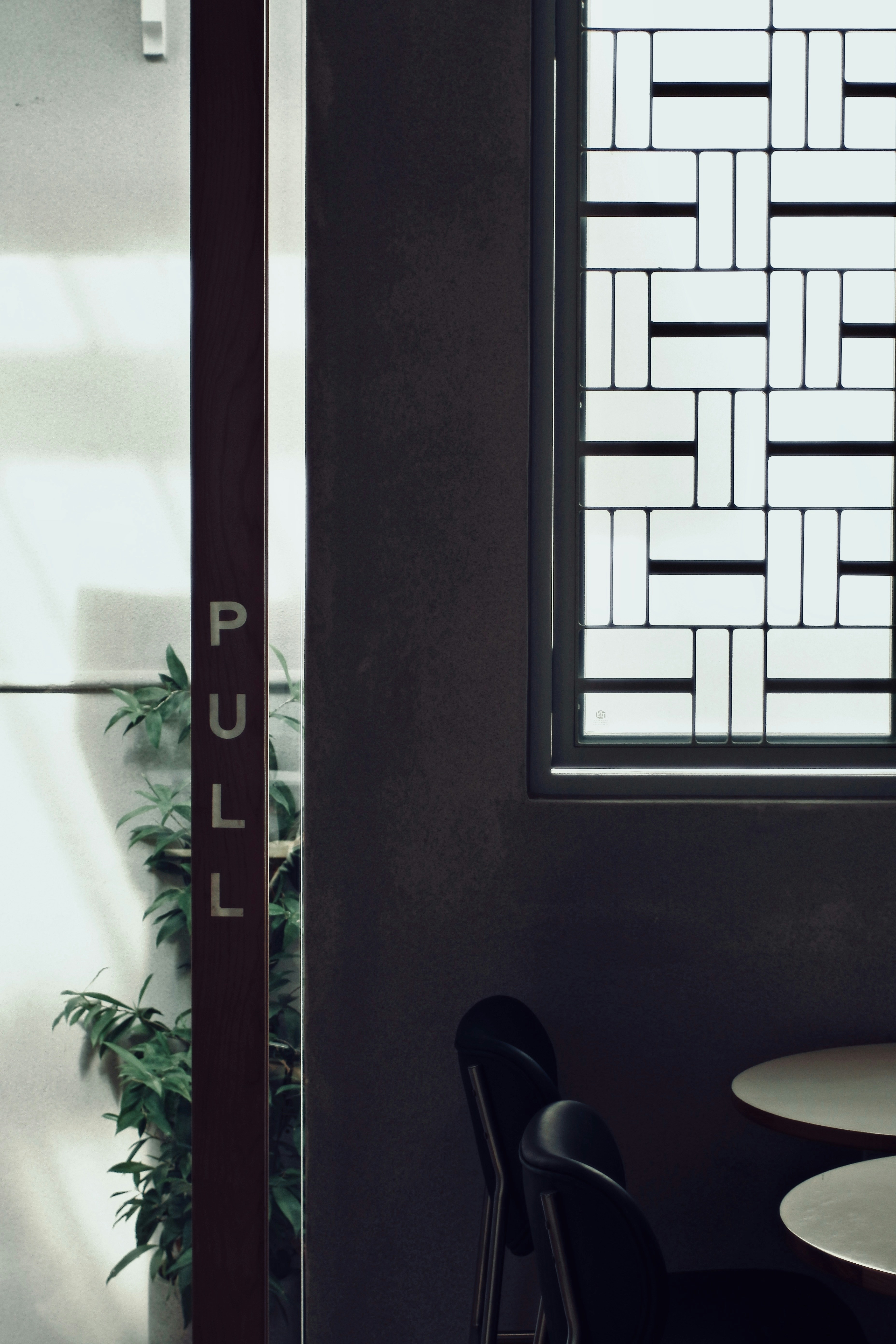 A table and chairs in a room with a window