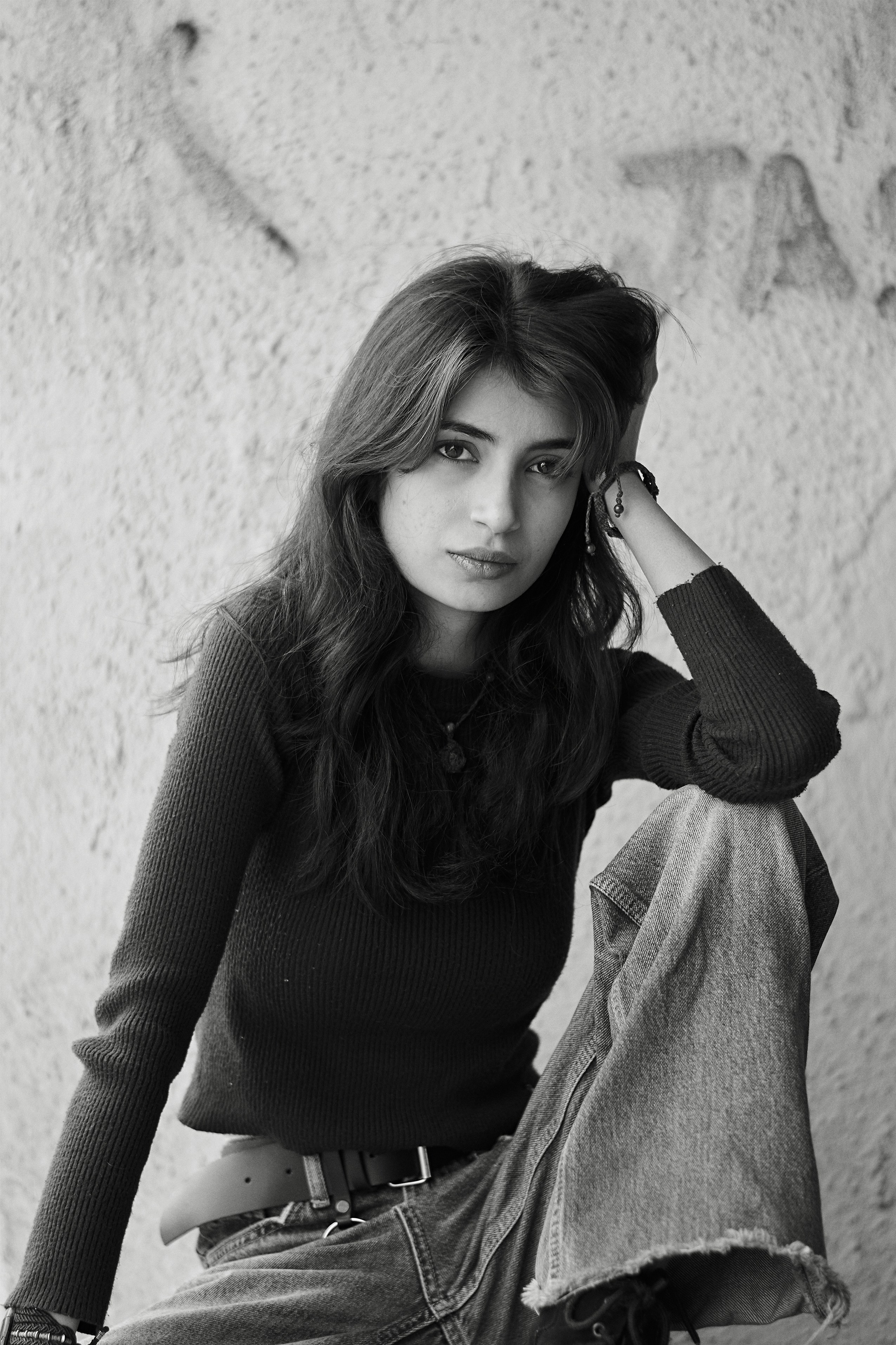 A woman sitting on the ground with her legs crossed