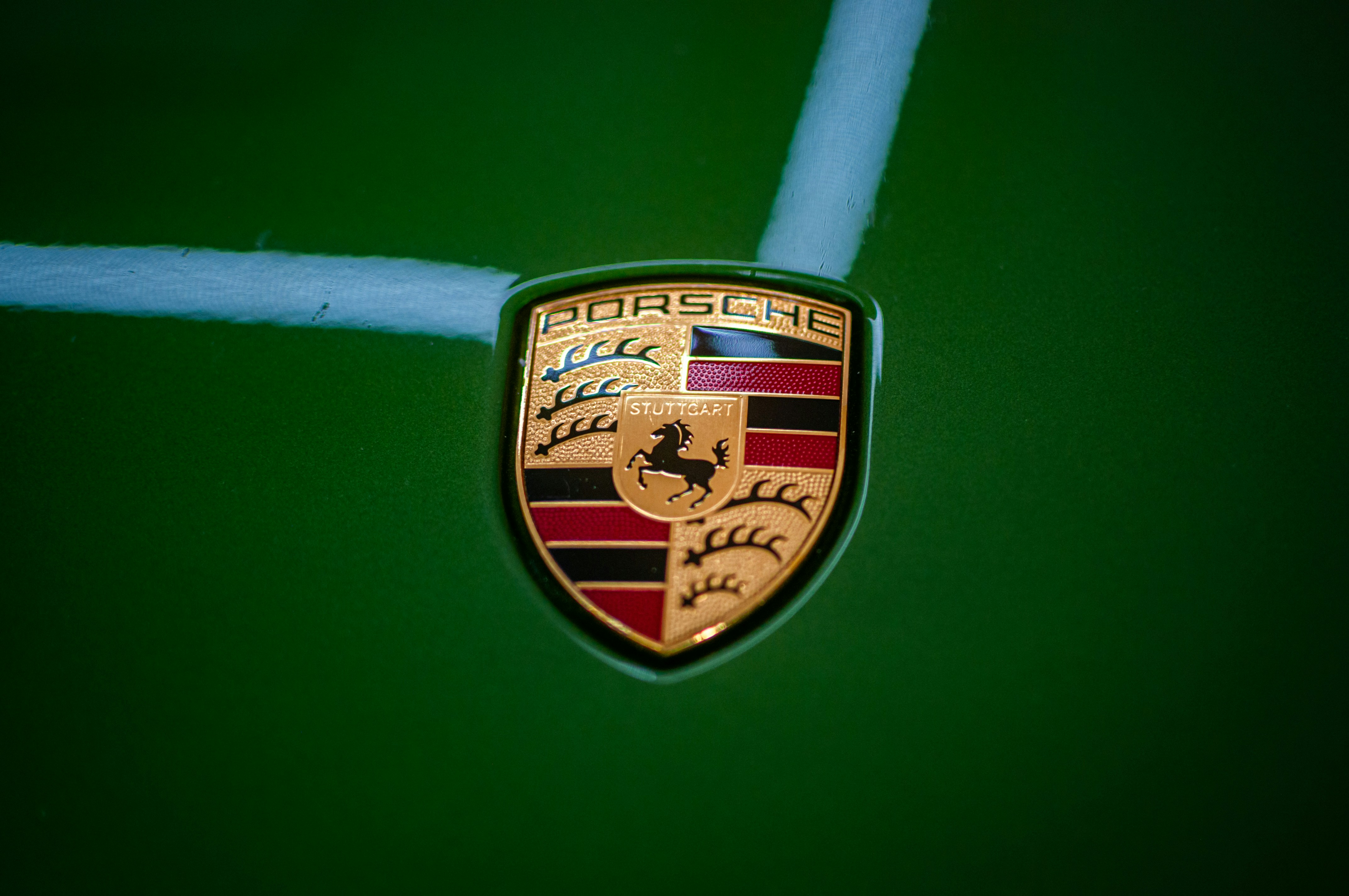 A close up of a porsche emblem on a car
