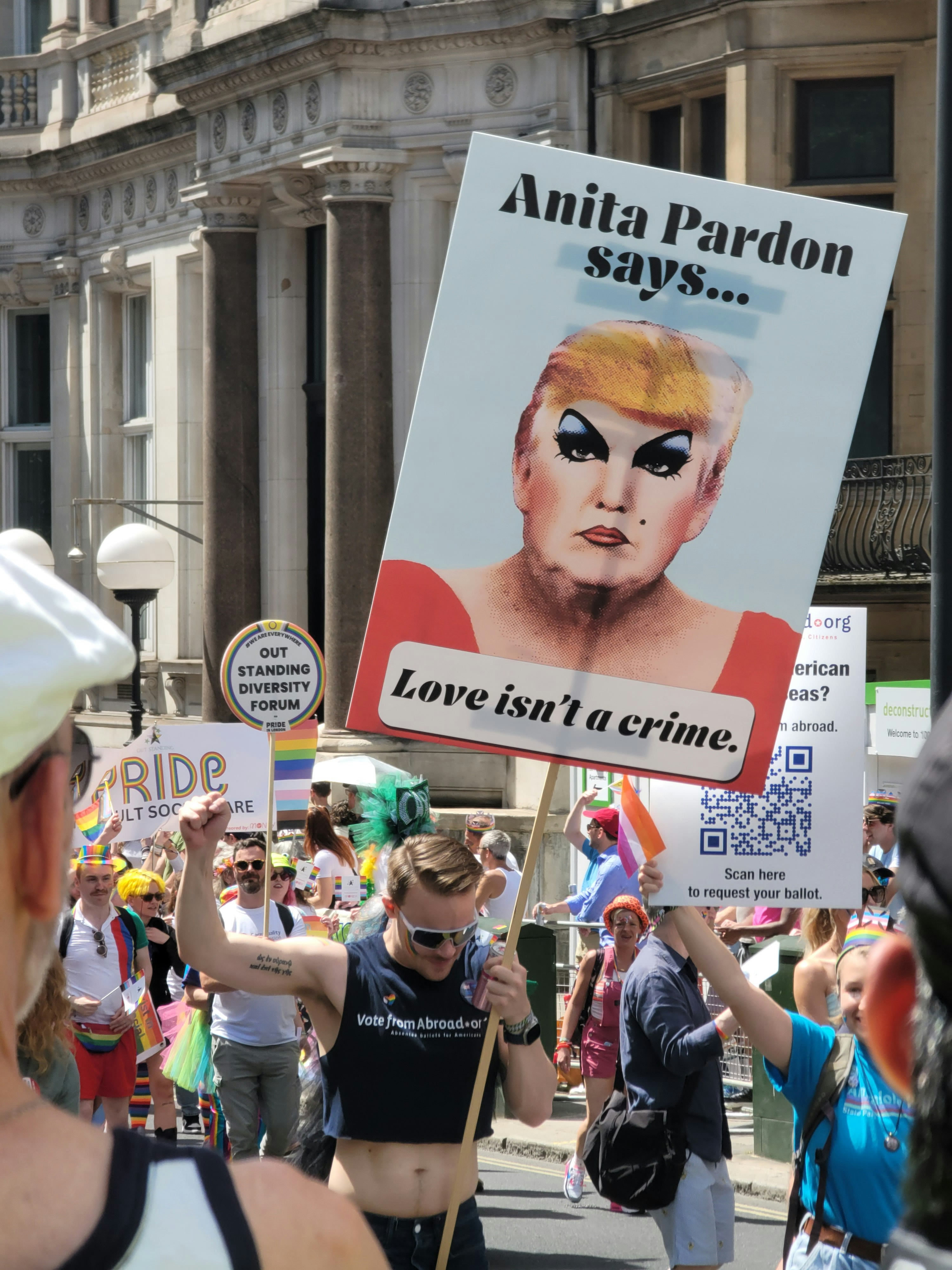 A group of people marching down a street holding signs