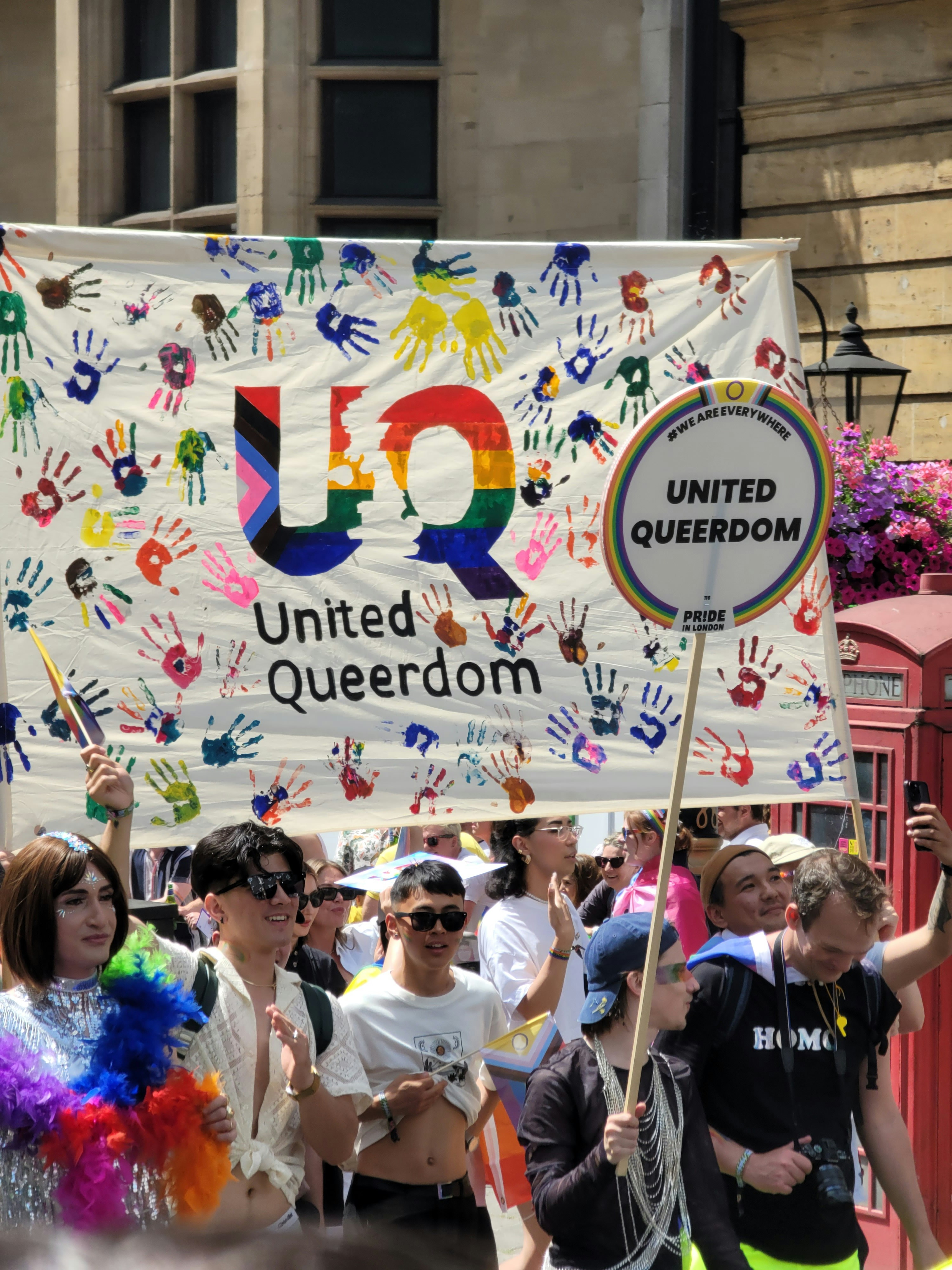 a group of people marching down a street holding signs