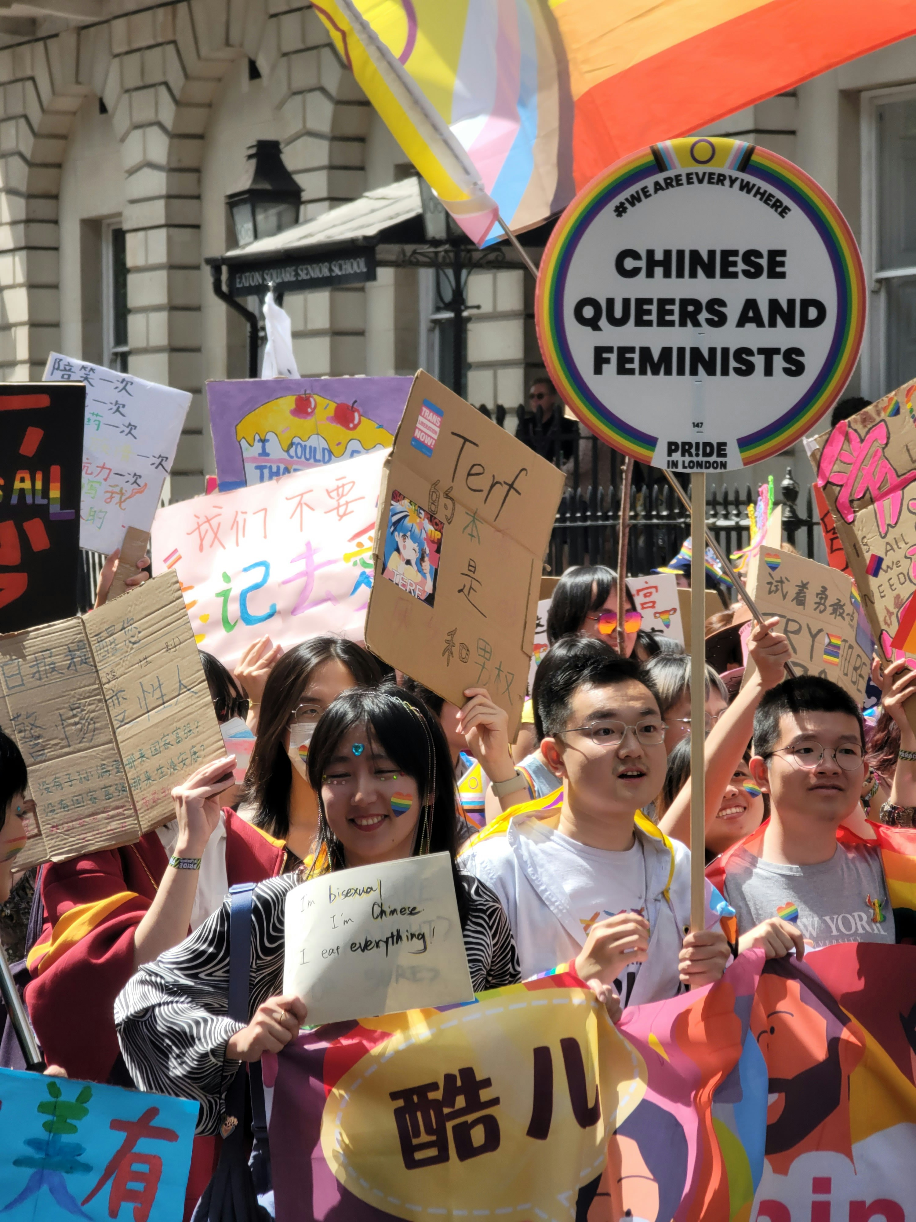 A group of people holding up signs and flags