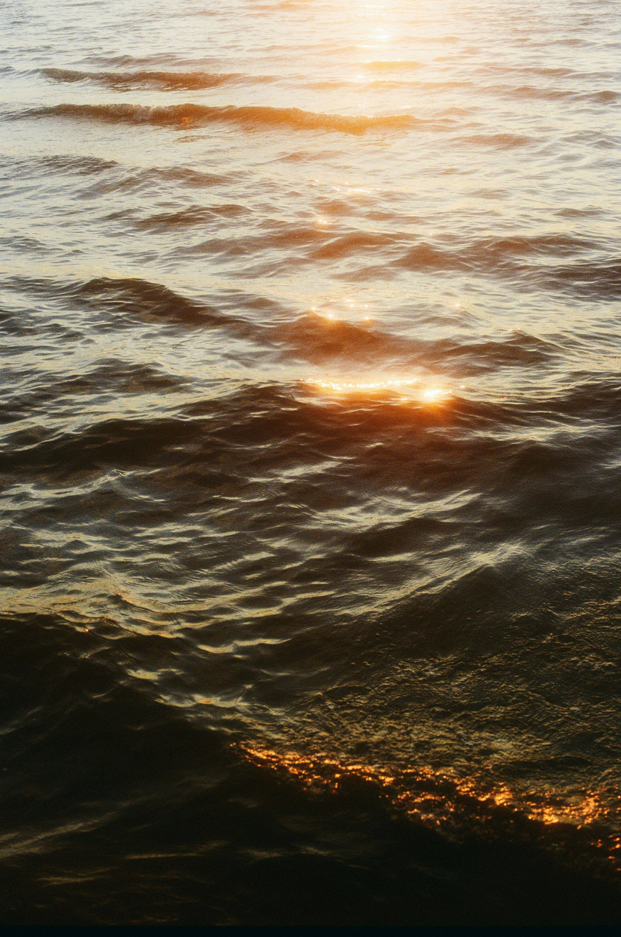 The sun is setting over the ocean water