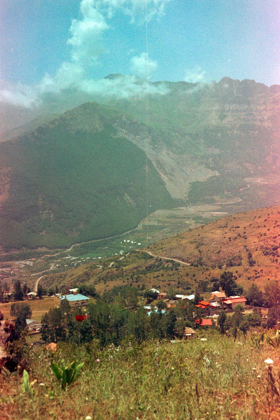 Mountain landscape with a lush valley nestled between two mountains on either side