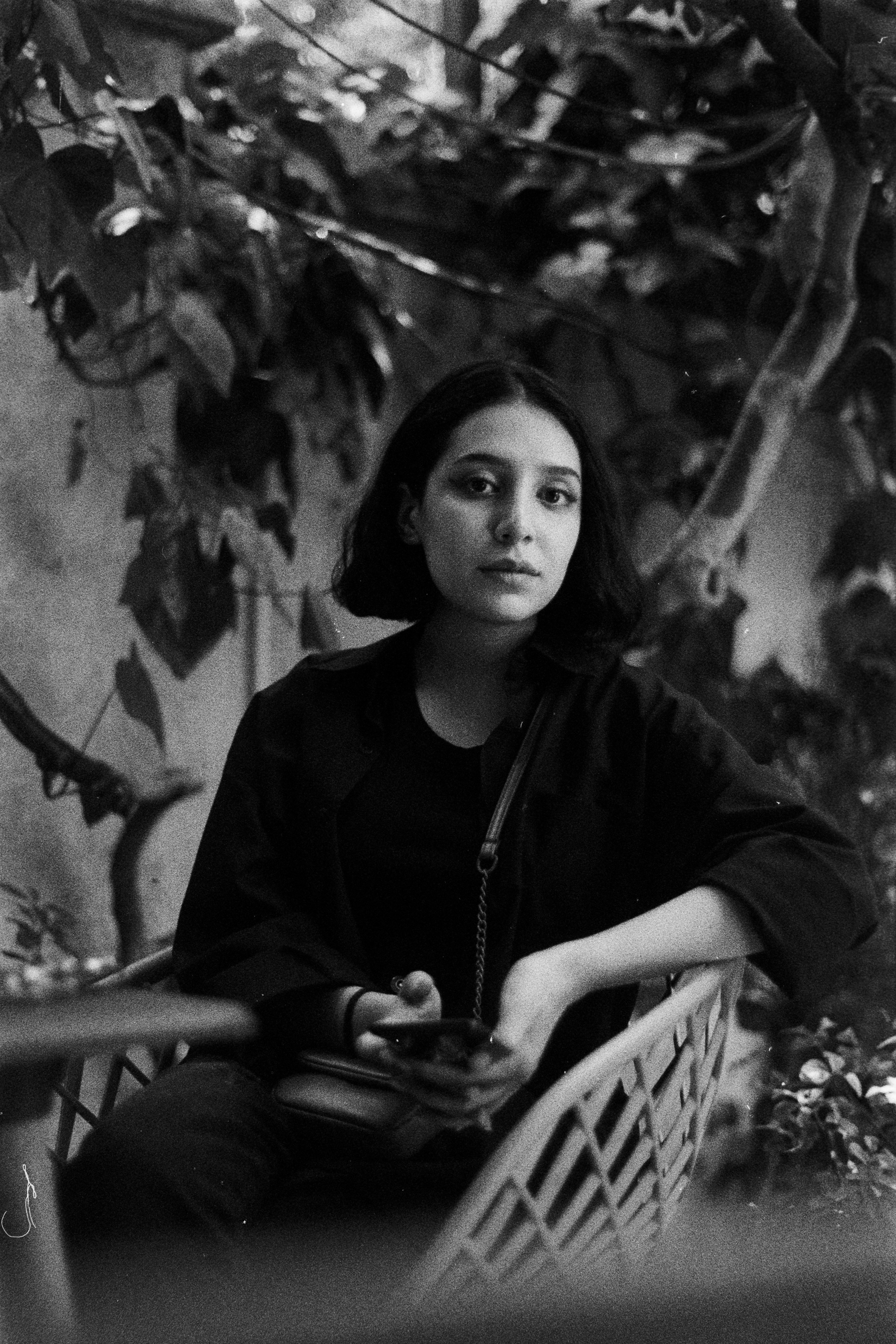 A black and white photo of a woman sitting in a chair photo – Free ...
