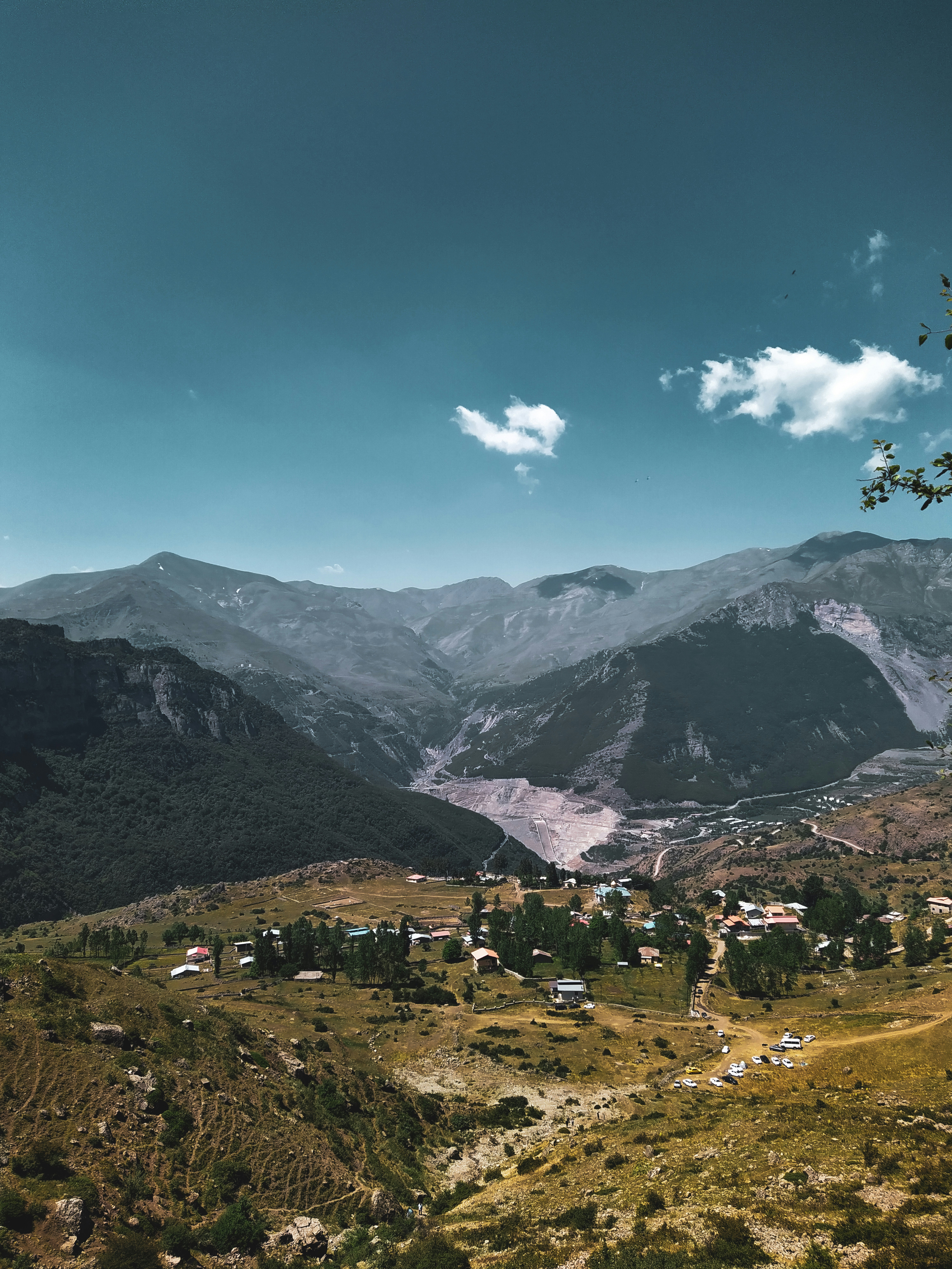 A view of a valley with mountains in the background