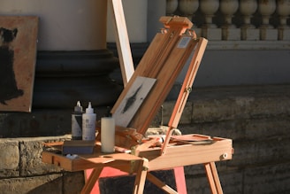 A wooden easel with a painting on top of it