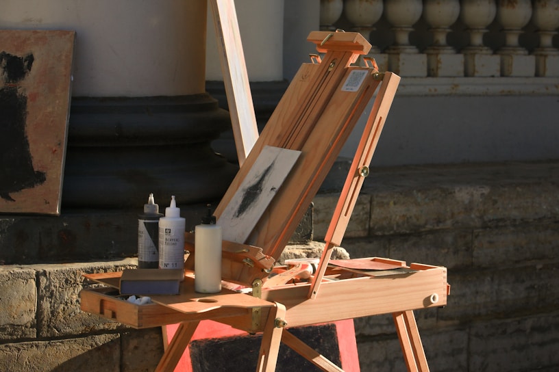 A wooden easel with a painting on top of it