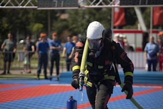A man in a diving suit is holding a pole