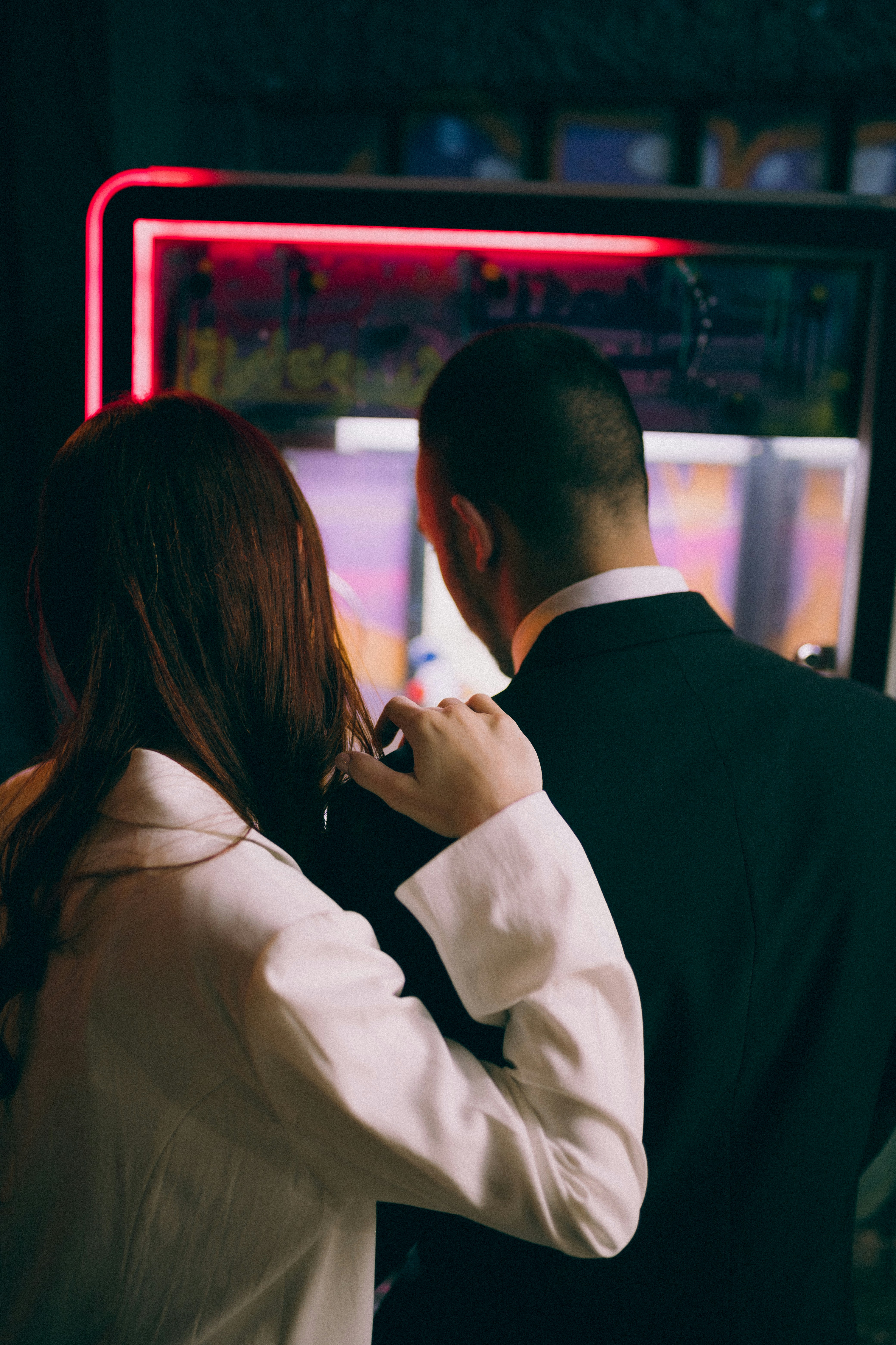 A man and a woman standing in front of a TV