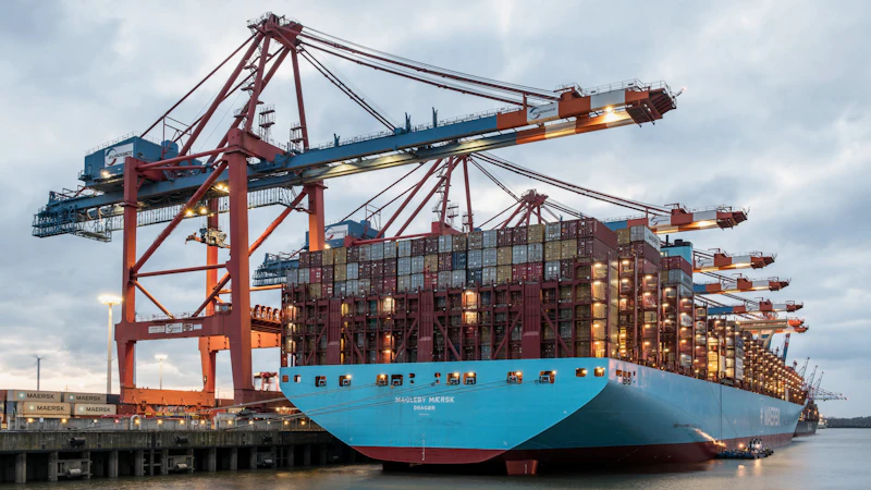 Container ship being loaded at port by gantry cranes, representing logistics and trade coordination