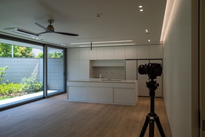 A camera is set up to take a picture of a kitchen