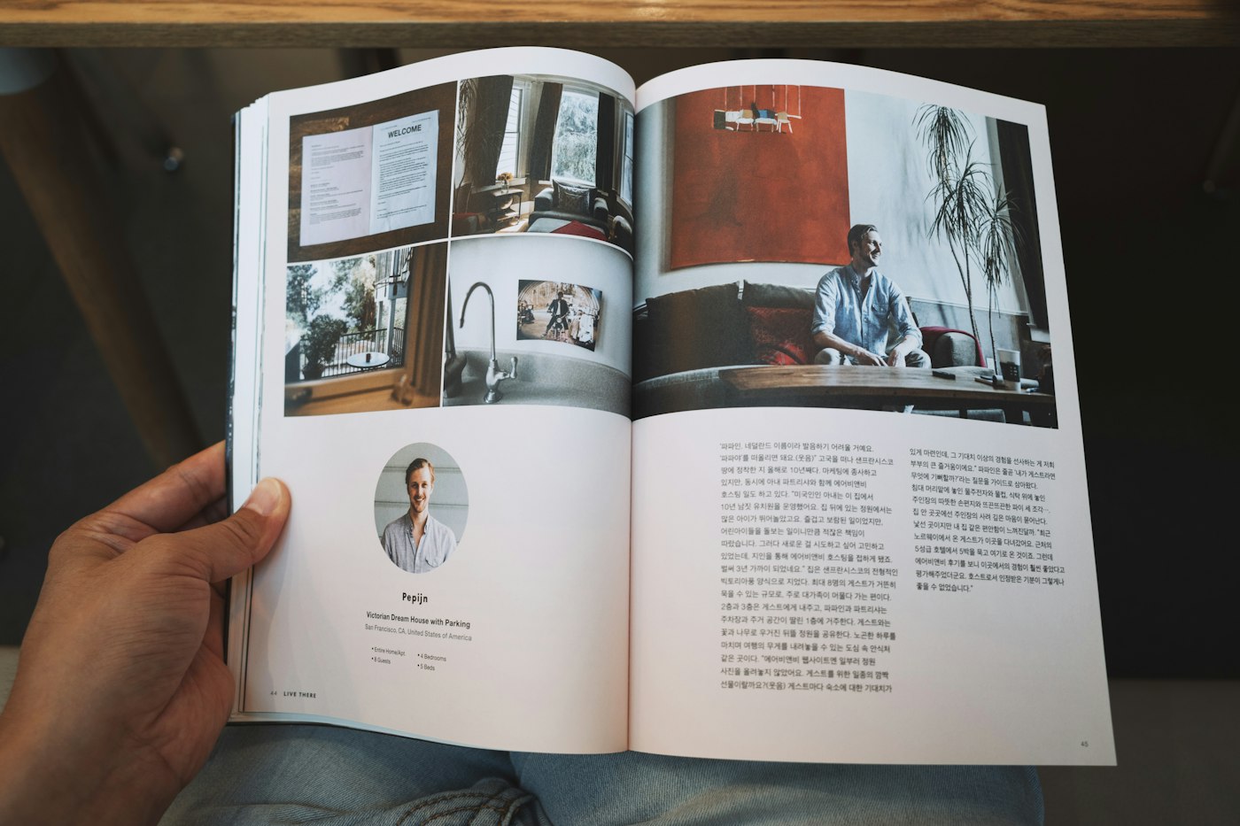 Person holding an open printed booklet