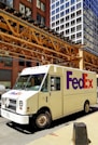 A fedex truck parked on the side of the road