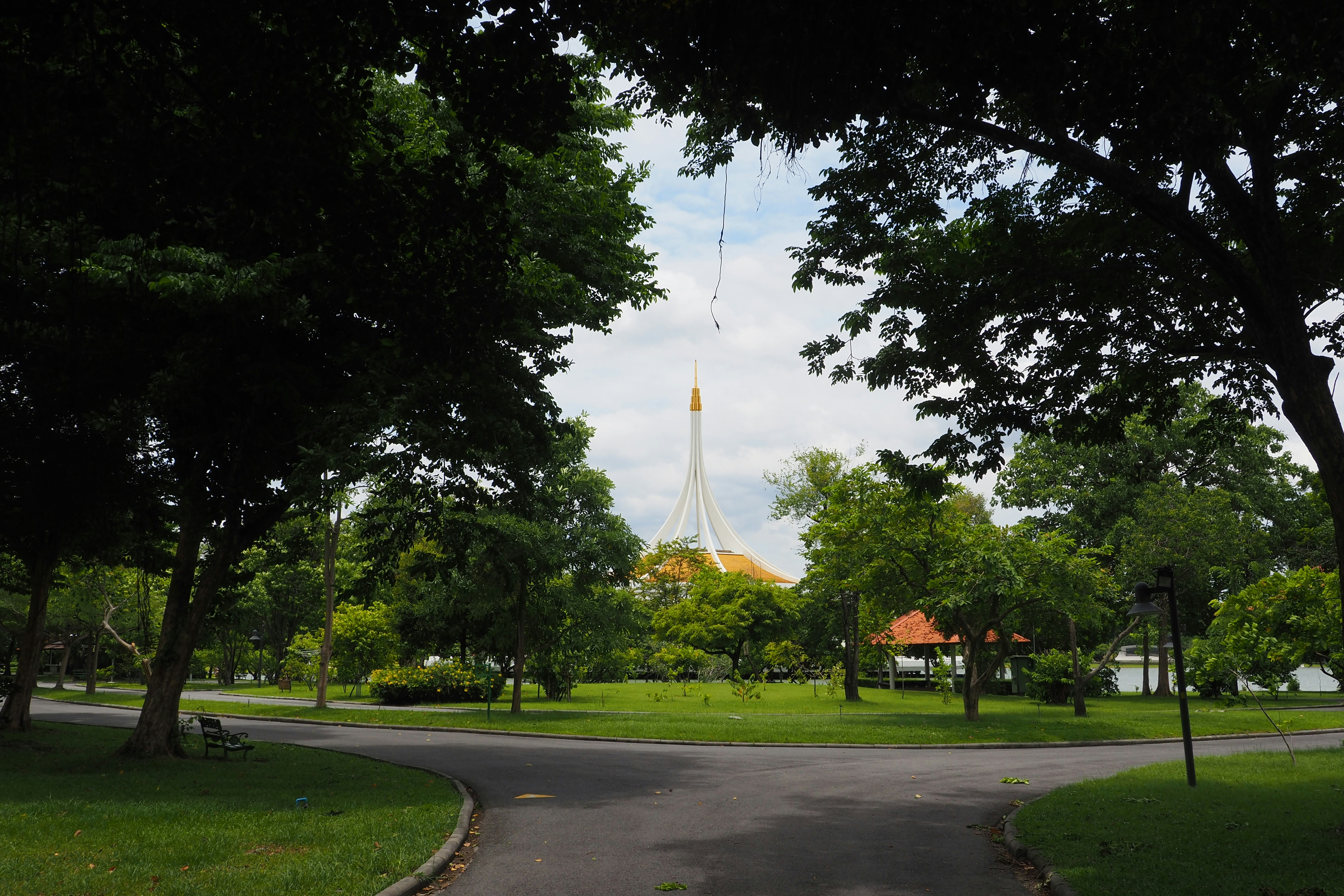 A view of a park with a tower in the background