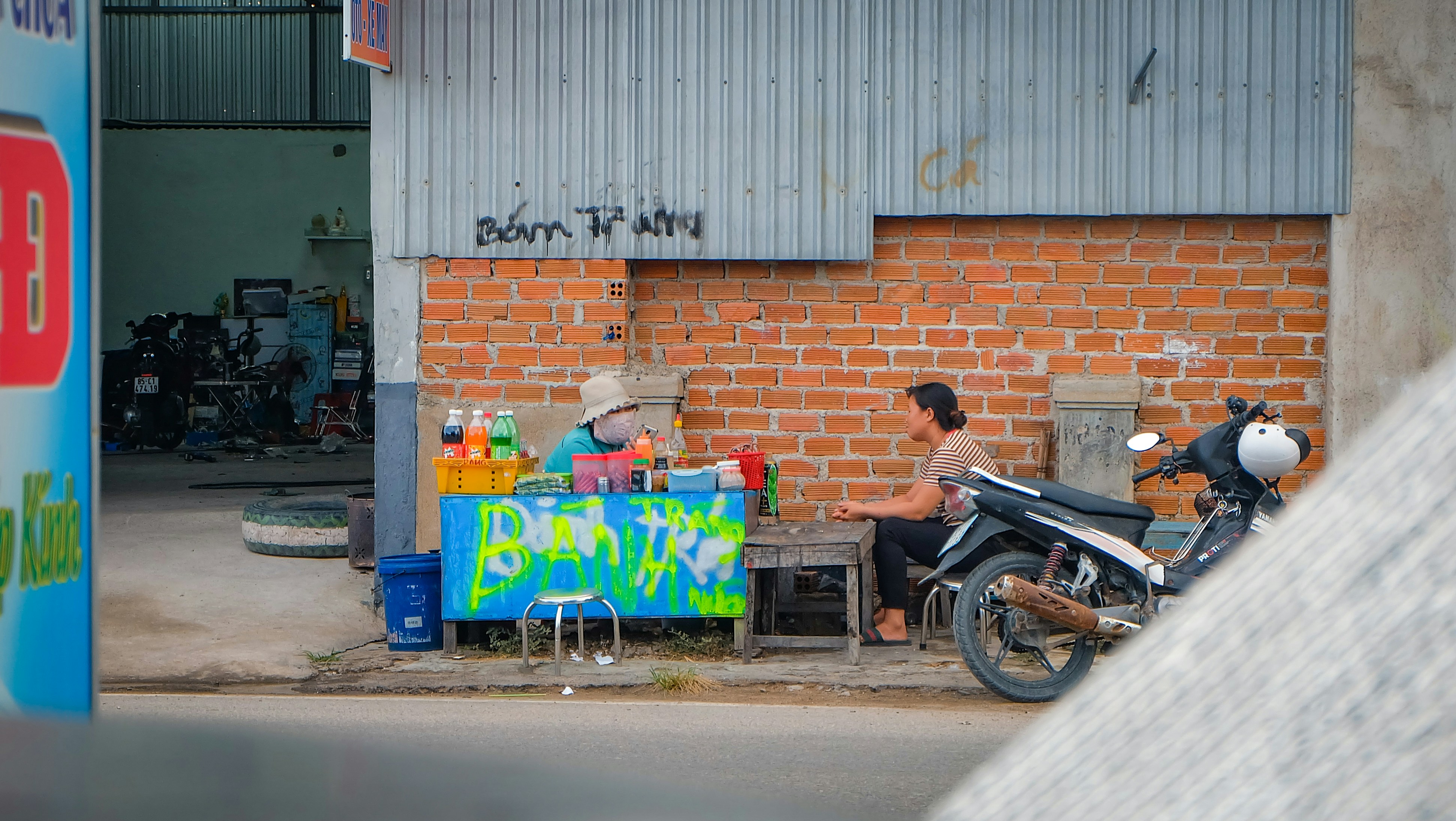 A motorcycle parked in front of a brick building