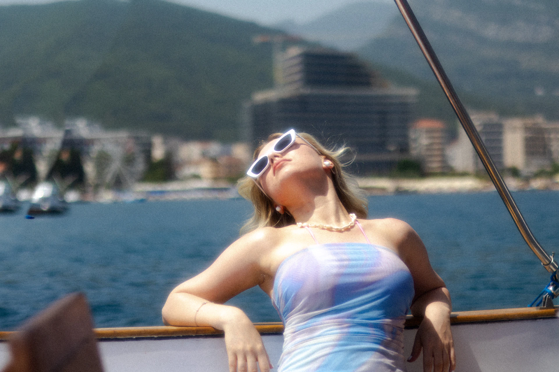A woman in a blue and white dress on a boat