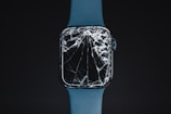 An apple watch with a cracked glass case