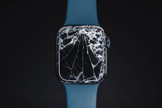 An apple watch with a cracked glass case