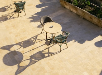 A couple of chairs and a table on a patio