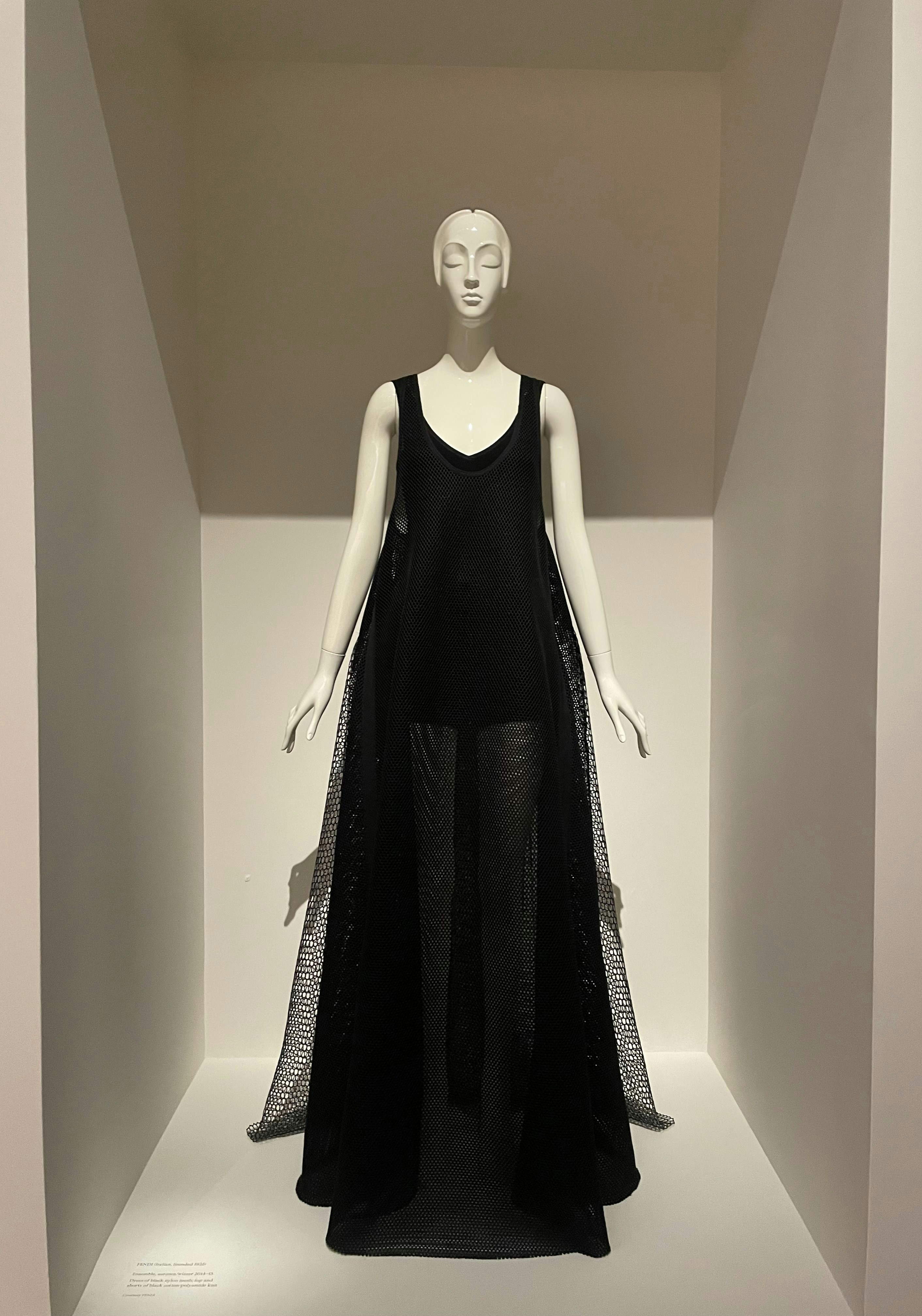 Sand satin slip midi dress displayed on a mannequin in a bright white minimal studio