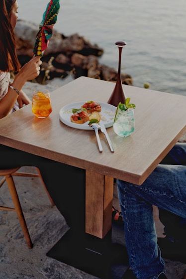 A man and a woman sitting at a table with a plate of food