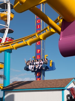 A group of people riding on top of a roller coaster