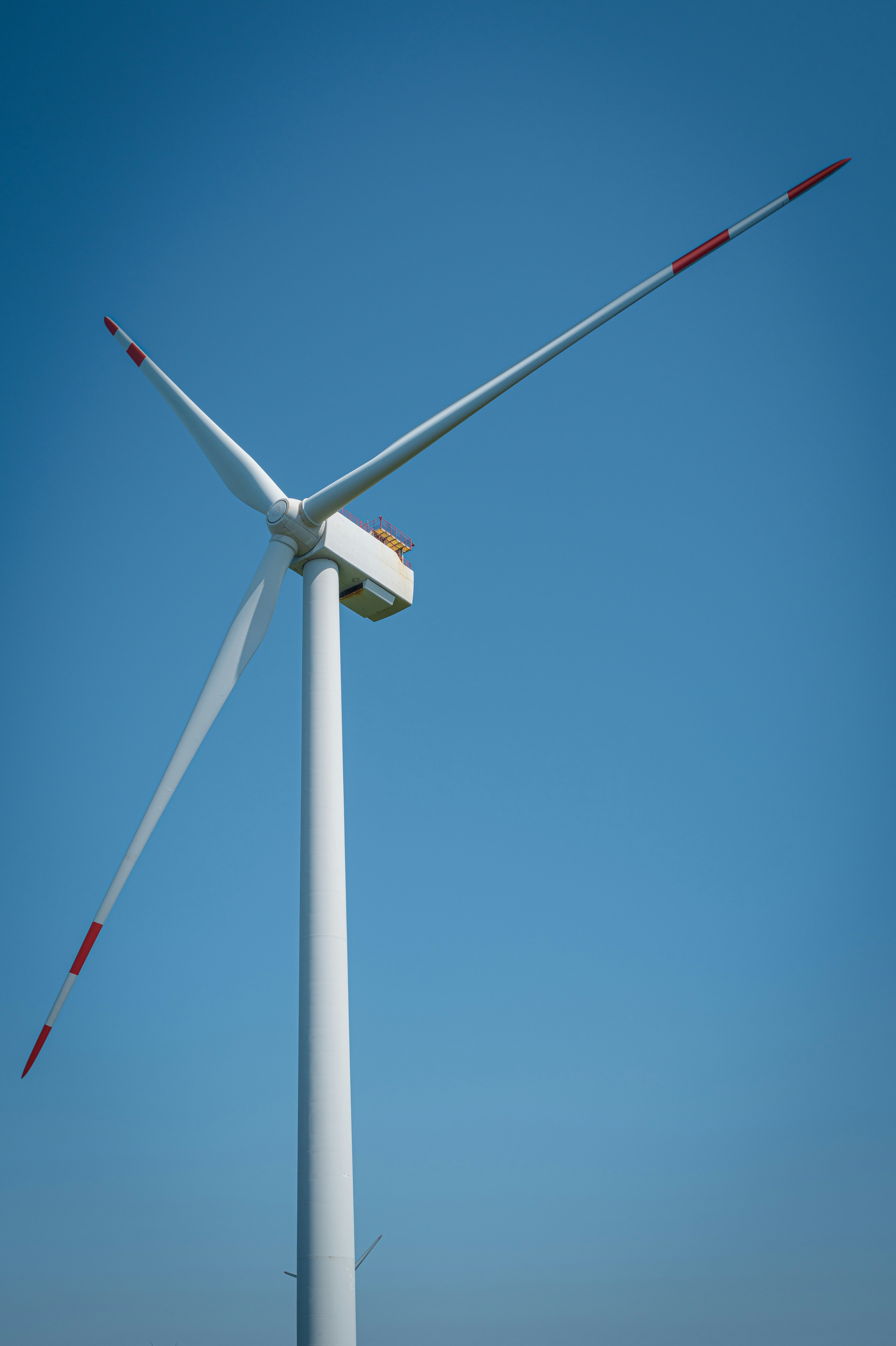 A wind turbine on the side of a road