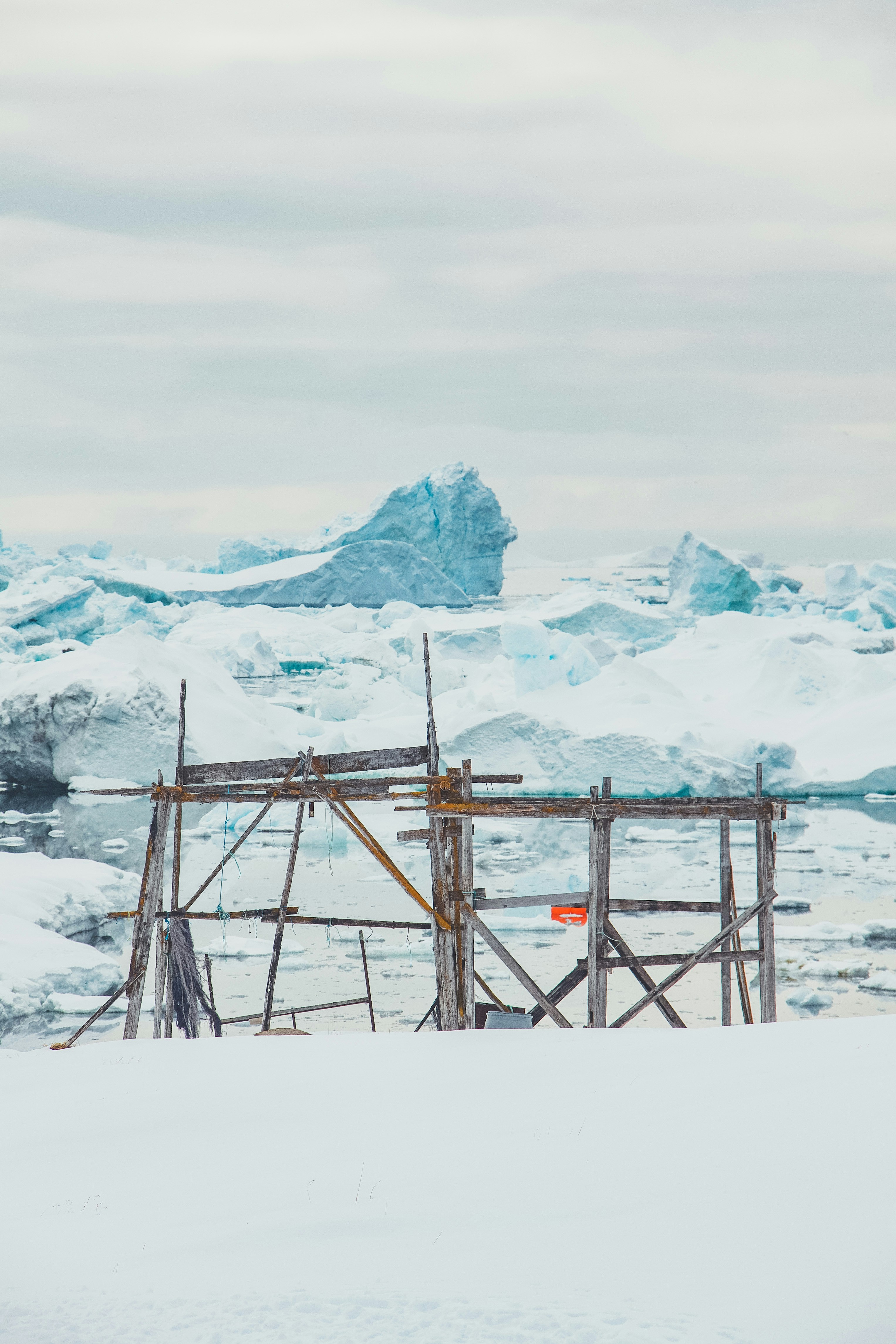 A group of people standing on top of a snow covered slope